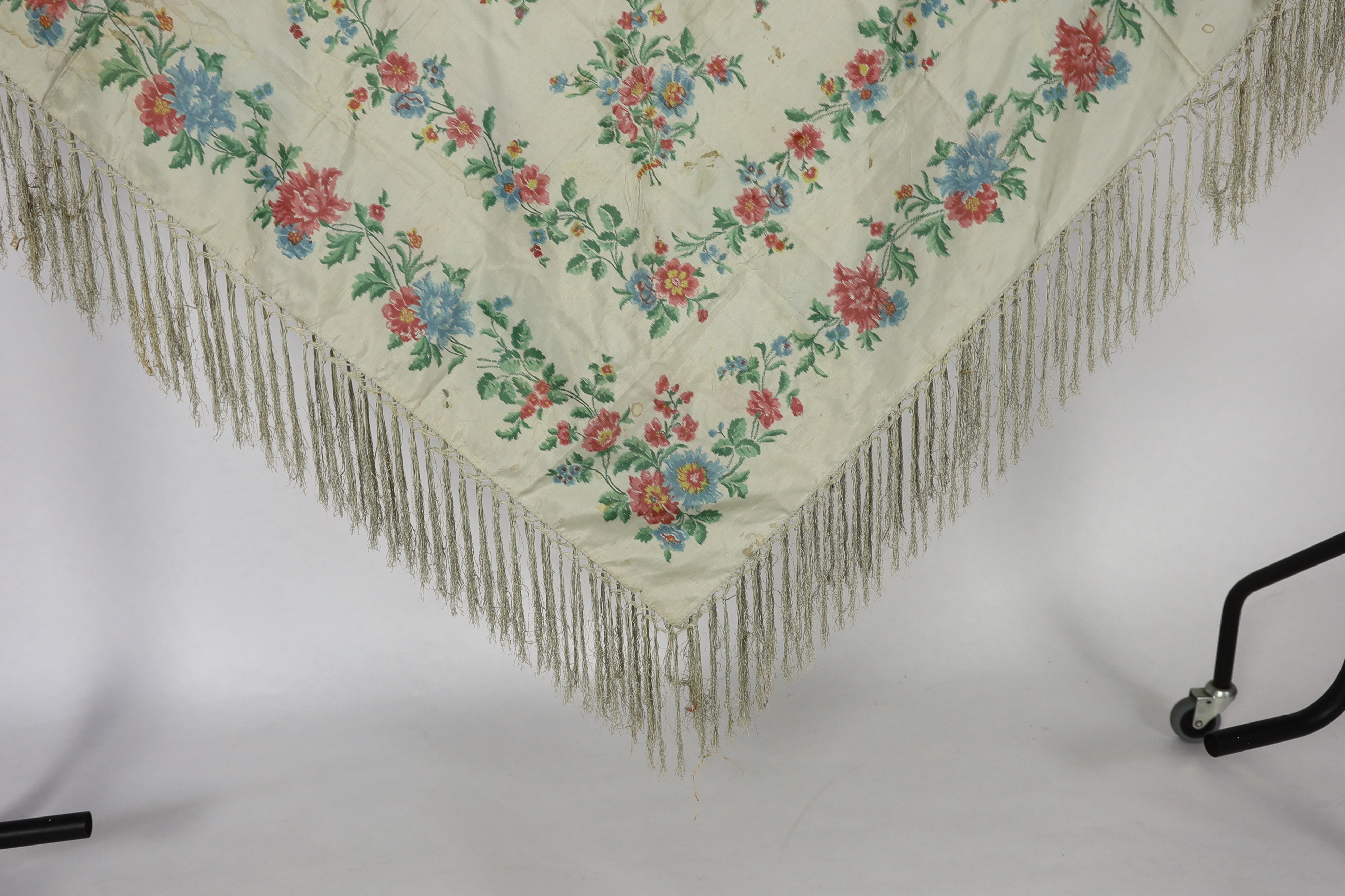 A French silk shawl, c.1800-1840, of a type modelled by Madame Recamier in the painting by François Gerard, printed on the warp thread into a rose pattern, with long fringing, 174 x 170cm